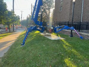 This is an atrium boom lift set up on a lawn that is sloped.